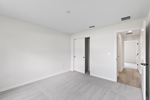 10 Reine Pl, Palm Coast, FL 32164 - unfurnished bedroom with carpet, baseboards, and a closet