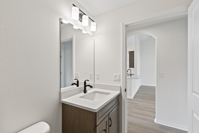 10 Reine Pl, Palm Coast, FL 32164 - bathroom featuring vanity, toilet, wood finished floors, and baseboards