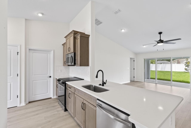 10 Reine Pl, Palm Coast, FL 32164 - kitchen featuring stainless steel appliances, a sink, light wood-style floors, ceiling fan, and vaulted ceiling