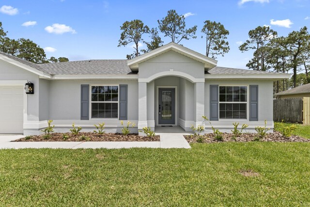 10 Reine Pl, Palm Coast, FL 32164 - ranch-style home featuring a shingled roof, an attached garage, and stucco siding