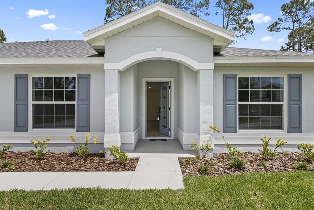 10 Reine Pl, Palm Coast, FL 32164 - view of exterior entry with a shingled roof