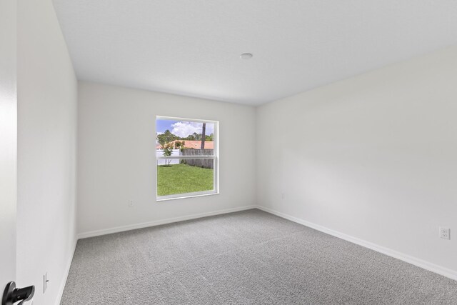10 Reine Pl, Palm Coast, FL 32164 - empty room featuring carpet and baseboards