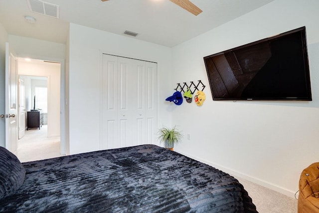 bedroom with light carpet, a closet, and ceiling fan