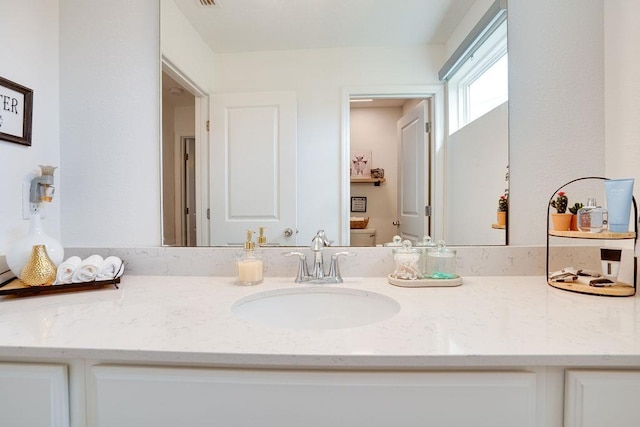 bathroom featuring toilet and vanity