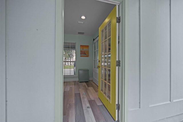 washroom featuring light wood-type flooring and stacked washer and dryer