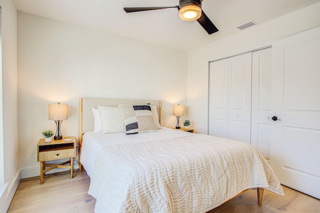 bedroom featuring ceiling fan, light hardwood / wood-style floors, and a closet