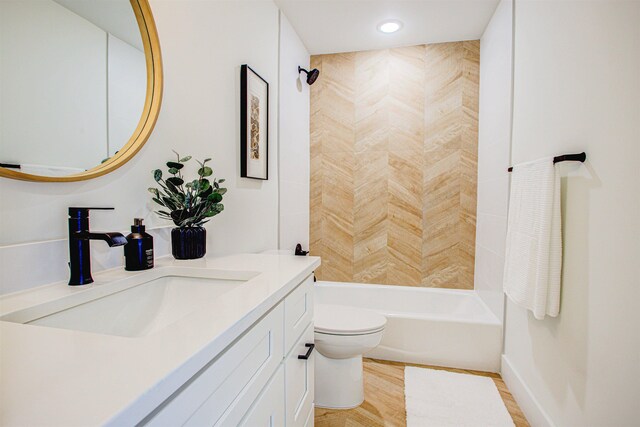 full bathroom featuring  shower combination, wood-type flooring, vanity, and toilet