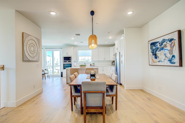 dining room with light wood-type flooring