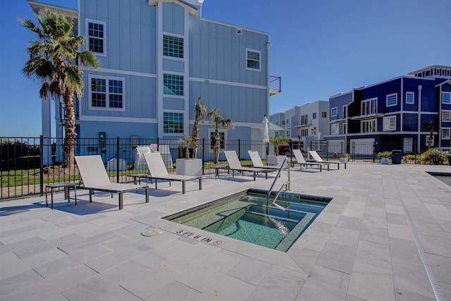 view of pool featuring a community hot tub and a patio area