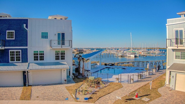 view of dock with a balcony and a water view