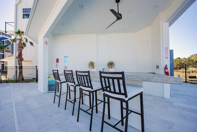 view of patio / terrace with a bar and ceiling fan