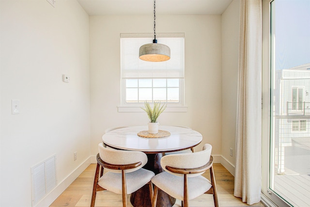 dining space with light wood-type flooring