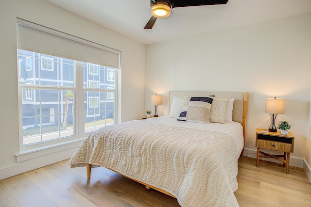 bedroom with hardwood / wood-style flooring and ceiling fan