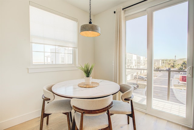 dining room with plenty of natural light and light hardwood / wood-style floors