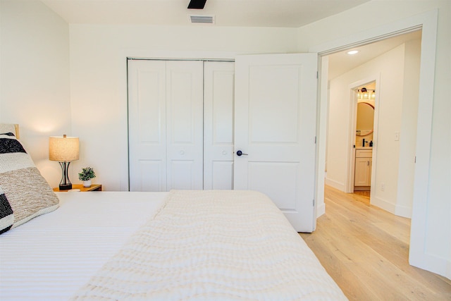 bedroom with ceiling fan, a closet, and light wood-type flooring