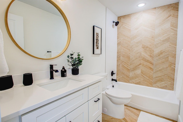 full bathroom featuring vanity, hardwood / wood-style flooring, toilet, and washtub / shower combination