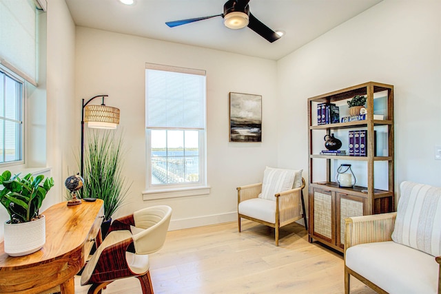 living area featuring ceiling fan and light wood-type flooring