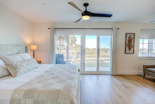 bedroom with access to exterior, light hardwood / wood-style floors, and ceiling fan