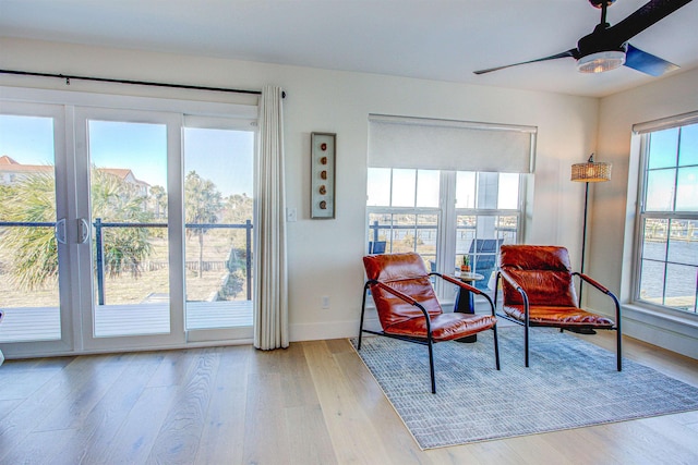 sitting room featuring ceiling fan and light hardwood / wood-style flooring