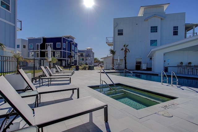 view of pool featuring a community hot tub and a patio