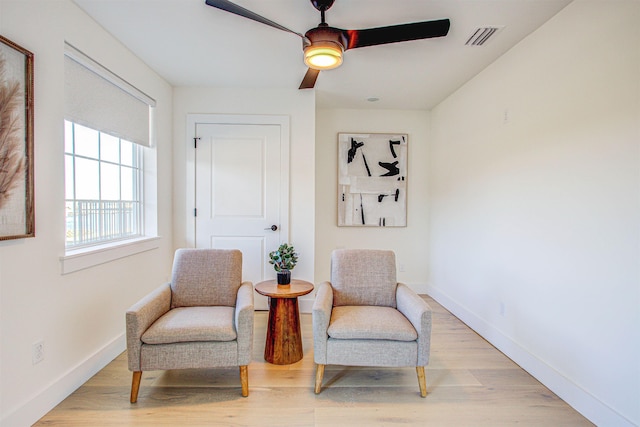 sitting room featuring ceiling fan and light wood-type flooring