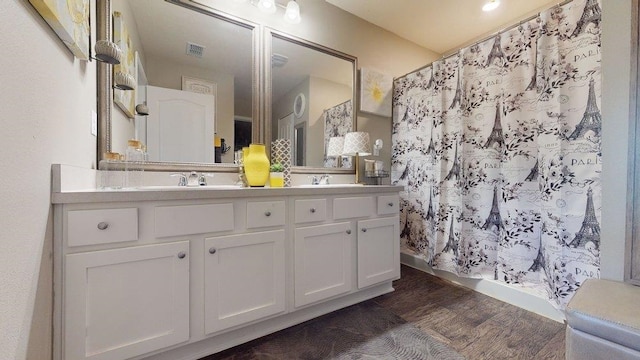 bathroom featuring vanity, curtained shower, and wood-type flooring