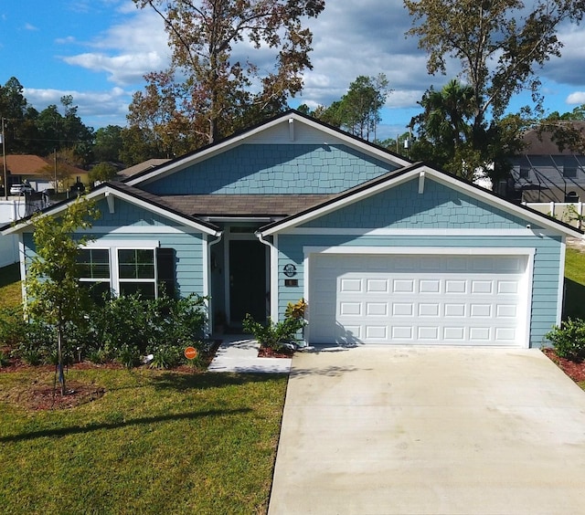 single story home with an attached garage, driveway, and a front lawn