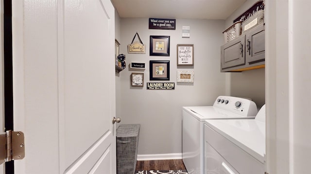 laundry area with cabinets, dark hardwood / wood-style flooring, and washer and clothes dryer