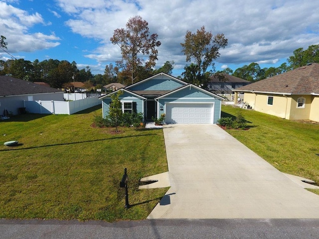 ranch-style house featuring a garage and a front lawn