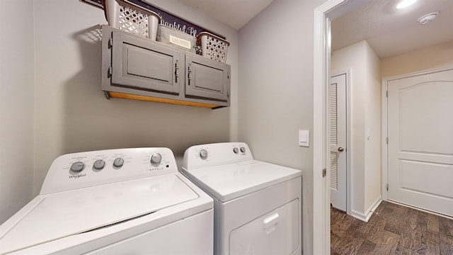 laundry area featuring dark hardwood / wood-style floors, cabinets, and separate washer and dryer