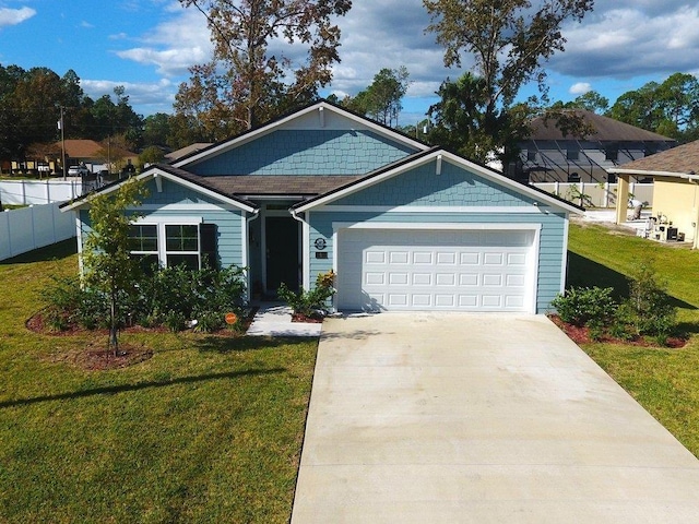 view of front of house with a garage and a front lawn