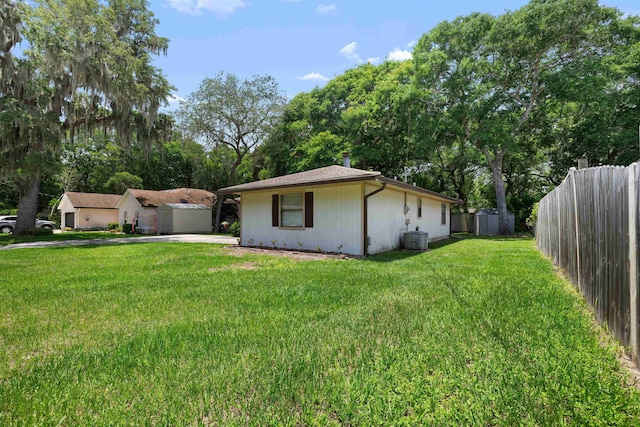 424 Orchis Rd, Saint Augustine, FL 32086 - rear view of house with driveway and view of scattered trees