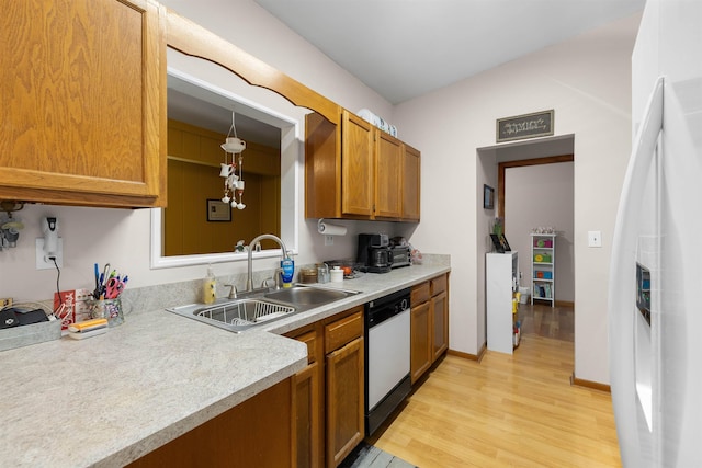424 Orchis Rd, Saint Augustine, FL 32086 - kitchen with white appliances, light wood-type flooring, brown cabinets, light countertops, and decorative light fixtures