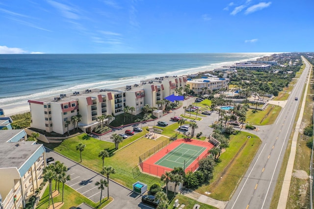 bird's eye view featuring a water view and a beach view