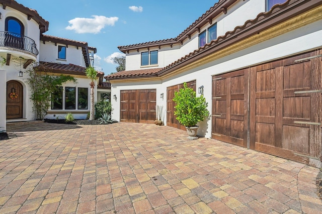 view of front of home featuring a balcony and a garage