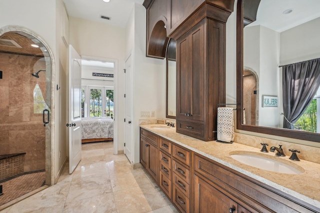 bathroom featuring vanity, a healthy amount of sunlight, and an enclosed shower