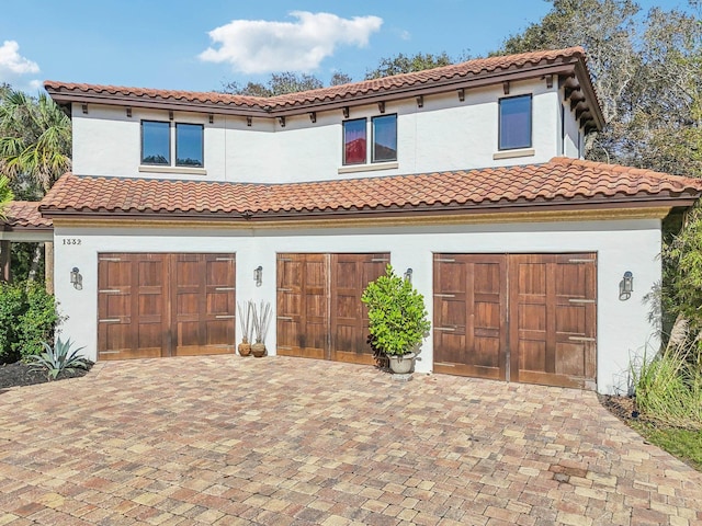 1332 Ponte Vedra Blvd, Ponte Vedra Beach, FL 32082 - mediterranean / spanish-style house featuring a garage, stucco siding, decorative driveway, and a tile roof