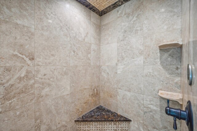 bathroom with a tile shower