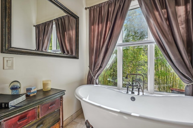 bathroom with a tub, plenty of natural light, and tile patterned flooring