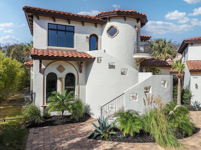 mediterranean / spanish-style home featuring a balcony