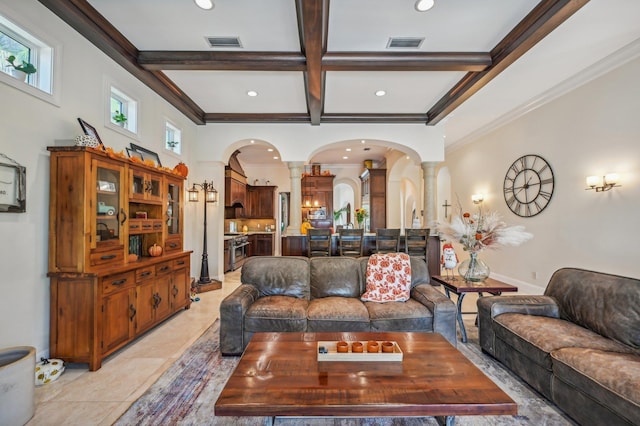 living room featuring beam ceiling, ornate columns, and crown molding