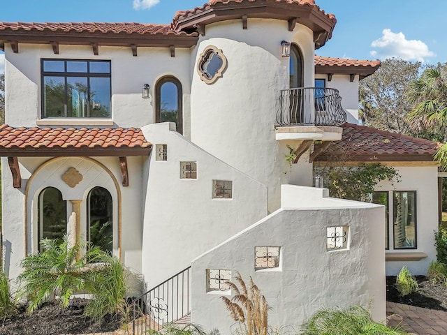 view of side of home with a balcony