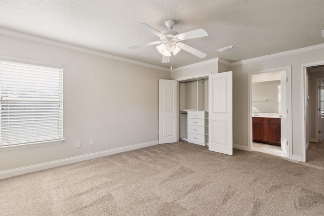 520 Weeping Willow Ln, Saint Augustine, FL 32080 - unfurnished bedroom with light carpet, a textured ceiling, crown molding, baseboards, and ensuite bath