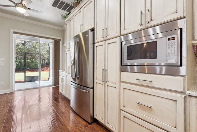 520 Weeping Willow Ln, Saint Augustine, FL 32080 - kitchen with appliances with stainless steel finishes, ornamental molding, dark wood-style flooring, a ceiling fan, and cream cabinetry