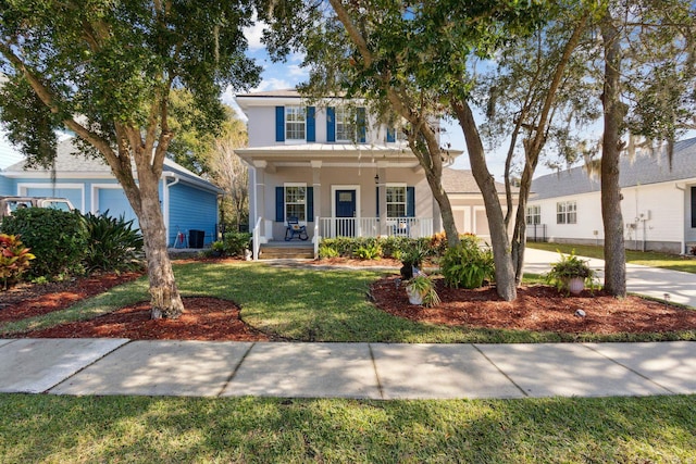 520 Weeping Willow Ln, Saint Augustine, FL 32080 - view of front of home with a porch, stucco siding, a front yard, and central AC
