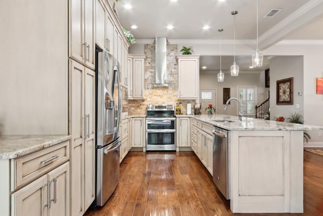 520 Weeping Willow Ln, Saint Augustine, FL 32080 - kitchen featuring appliances with stainless steel finishes, a sink, wall chimney exhaust hood, a peninsula, and crown molding