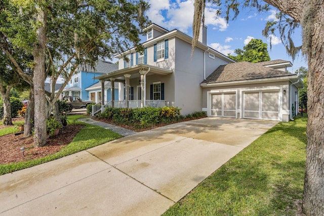 520 Weeping Willow Ln, Saint Augustine, FL 32080 - view of front facade with covered porch, driveway, a garage, stucco siding, and a chimney
