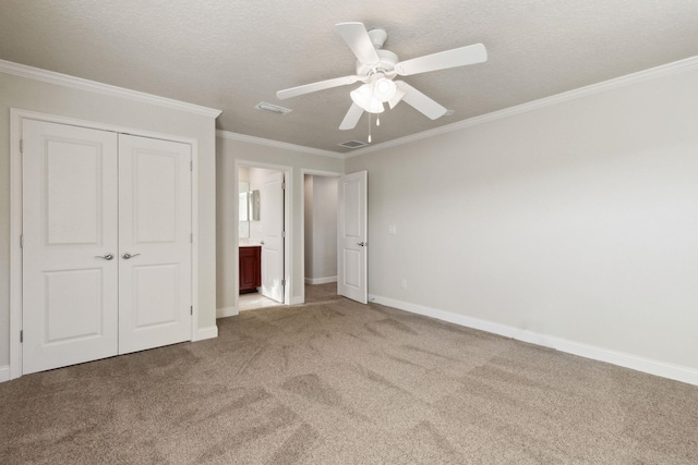 520 Weeping Willow Ln, Saint Augustine, FL 32080 - unfurnished bedroom with carpet floors, ornamental molding, a closet, baseboards, and a textured ceiling