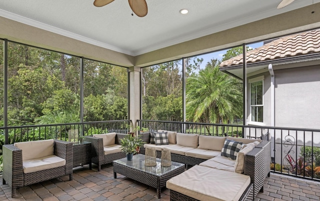 sunroom / solarium featuring ceiling fan and a healthy amount of sunlight