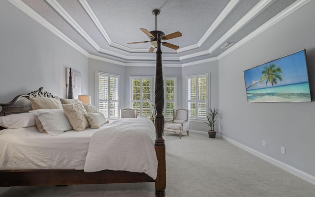 carpeted bedroom featuring a textured ceiling, a raised ceiling, ceiling fan, and ornamental molding